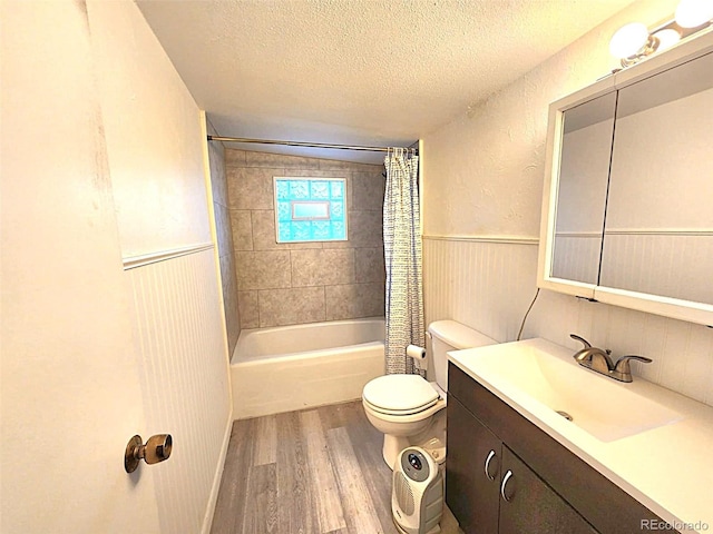 402 E 5th St, Julesburg, CO 80737 - bathroom with wood finished floors, a textured ceiling, toilet, shower / bath combination with curtain, and vanity