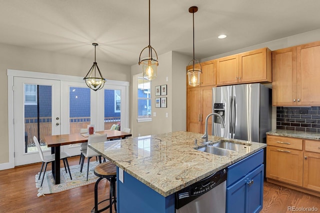 kitchen featuring appliances with stainless steel finishes, backsplash, a sink, and dark wood finished floors