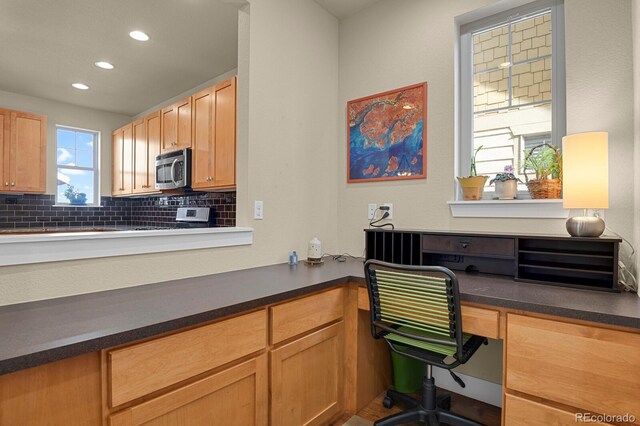 office space with recessed lighting and built in desk