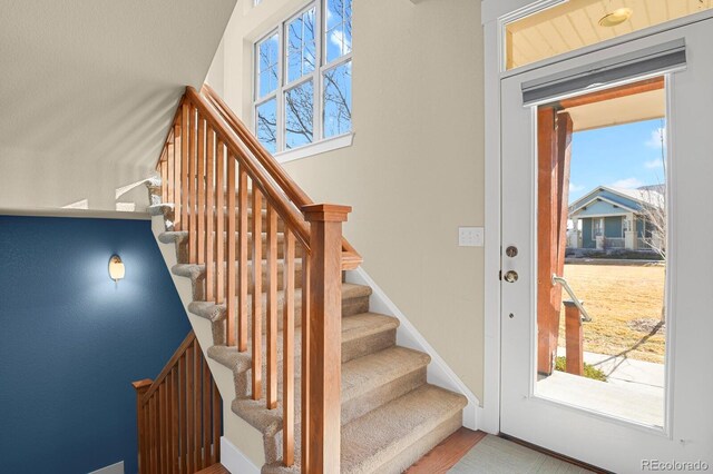 interior space with stairs and baseboards