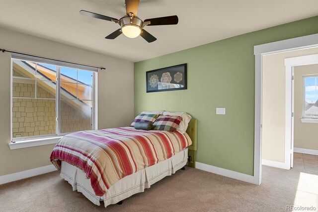 carpeted bedroom with a ceiling fan and baseboards