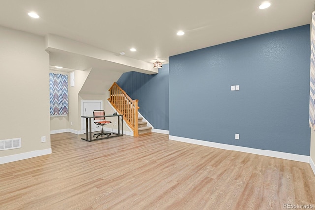 bonus room featuring wood finished floors, visible vents, baseboards, and stairs