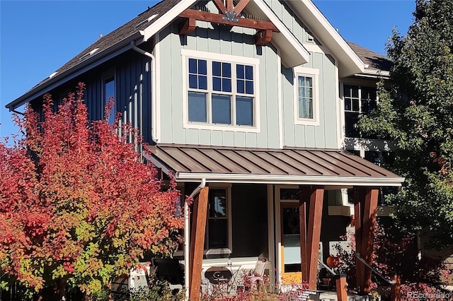 view of property exterior with a standing seam roof, metal roof, and board and batten siding