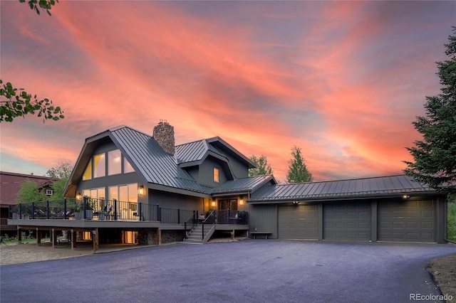 189 Pine Cone Ln, Winter Park, CO 80482 - view of front of house with a metal roof, a chimney, a standing seam roof, and stairway