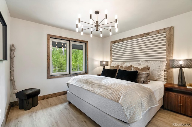 189 Pine Cone Ln, Winter Park, CO 80482 - bedroom featuring a chandelier and light wood-style flooring