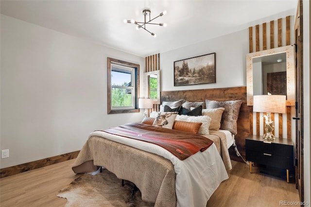 189 Pine Cone Ln, Winter Park, CO 80482 - bedroom featuring a chandelier and light wood finished floors