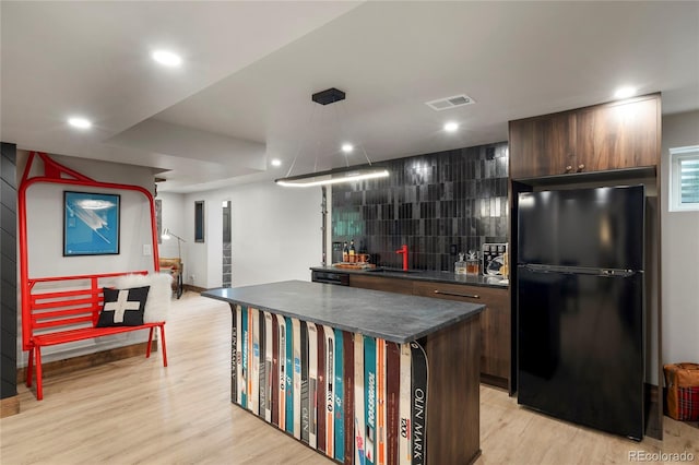189 Pine Cone Ln, Winter Park, CO 80482 - kitchen with freestanding refrigerator, dark countertops, light wood finished floors, a kitchen island, and recessed lighting