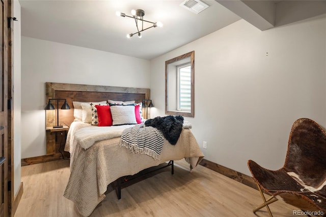 189 Pine Cone Ln, Winter Park, CO 80482 - bedroom featuring light wood-style floors and a chandelier