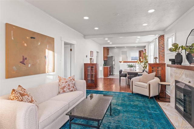 living room with ornamental molding, hardwood / wood-style floors, and a textured ceiling