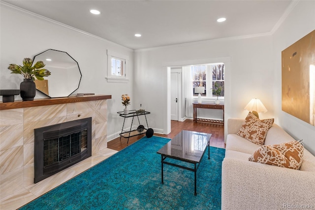 living room featuring a tiled fireplace, crown molding, heating unit, and hardwood / wood-style floors