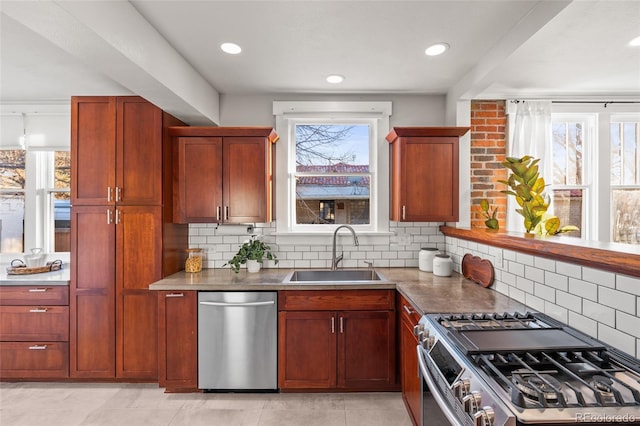 kitchen with sink, a healthy amount of sunlight, and appliances with stainless steel finishes