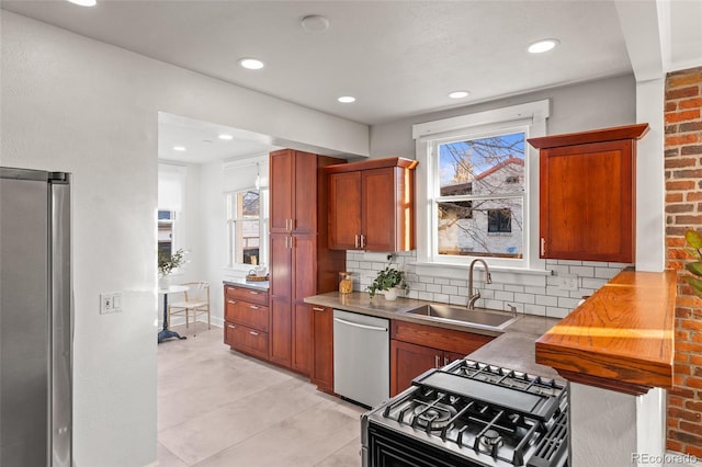 kitchen with appliances with stainless steel finishes, sink, and backsplash