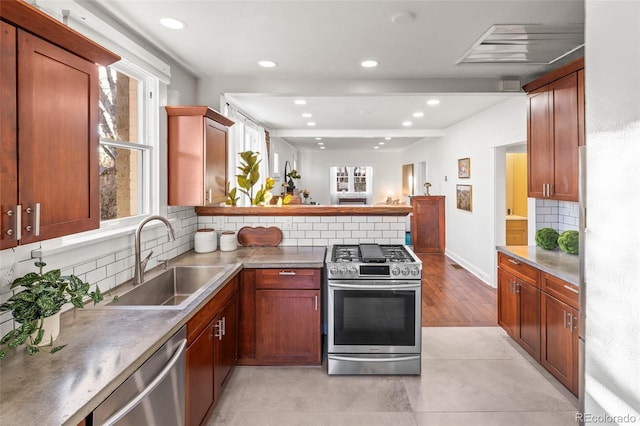 kitchen with sink, backsplash, stainless steel appliances, and light tile patterned flooring