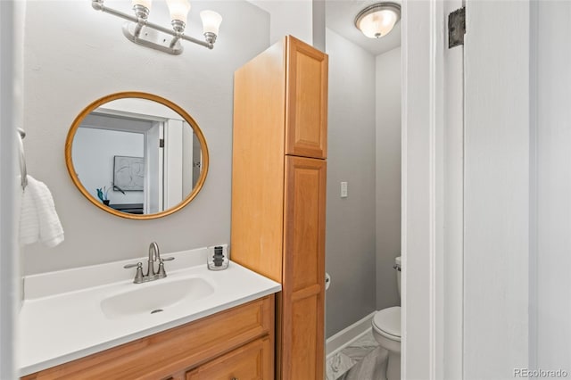 bathroom featuring vanity and toilet