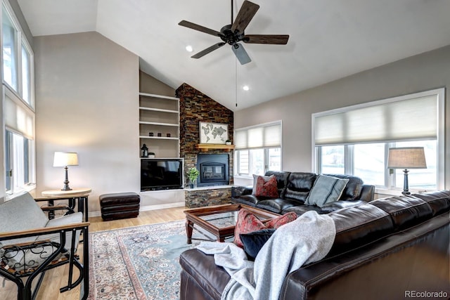 7877 S University Way, Centennial, CO 80122 - living room featuring wood finished floors, ceiling fan, a stone fireplace, built in features, and recessed lighting