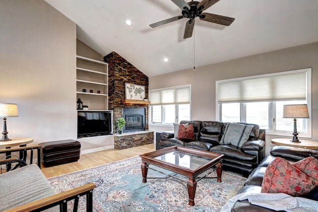 7877 S University Way, Centennial, CO 80122 - living area featuring wood finished floors, ceiling fan, a stone fireplace, recessed lighting, and vaulted ceiling