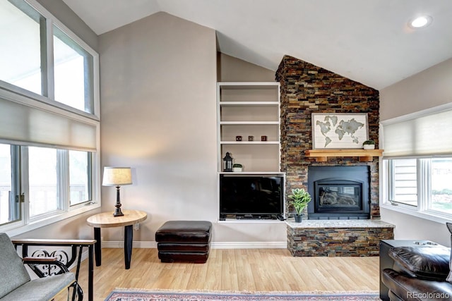 7877 S University Way, Centennial, CO 80122 - living area with wood finished floors, vaulted ceiling, a fireplace, recessed lighting, and baseboards