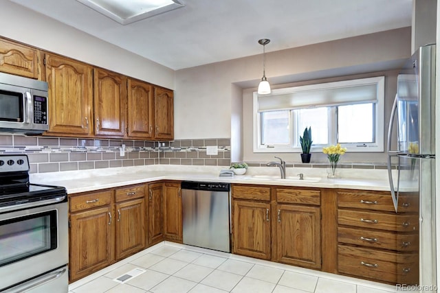 7877 S University Way, Centennial, CO 80122 - kitchen with appliances with stainless steel finishes, brown cabinetry, and light countertops