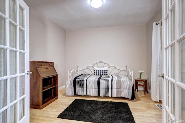 7877 S University Way, Centennial, CO 80122 - bedroom featuring french doors, wood finished floors, and baseboards