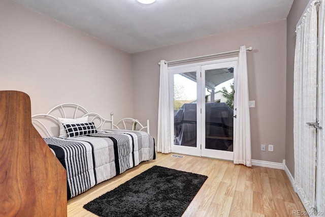 7877 S University Way, Centennial, CO 80122 - bedroom with access to exterior, wood finished floors, and baseboards