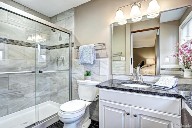 7877 S University Way, Centennial, CO 80122 - bathroom with vanity, toilet, a shower stall, tile walls, and a chandelier