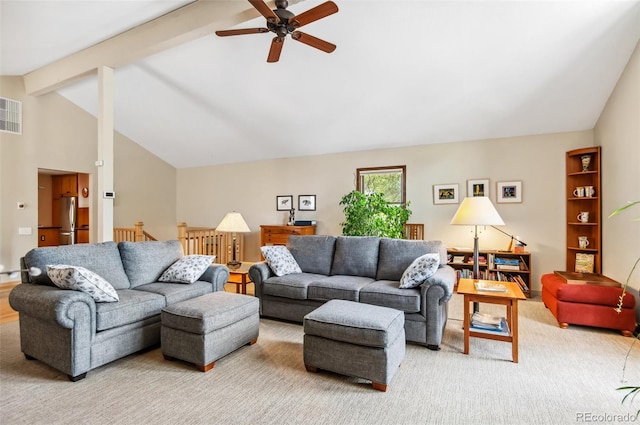 living room featuring lofted ceiling with beams, light colored carpet, and ceiling fan