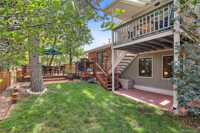 view of yard featuring a wooden deck and a patio