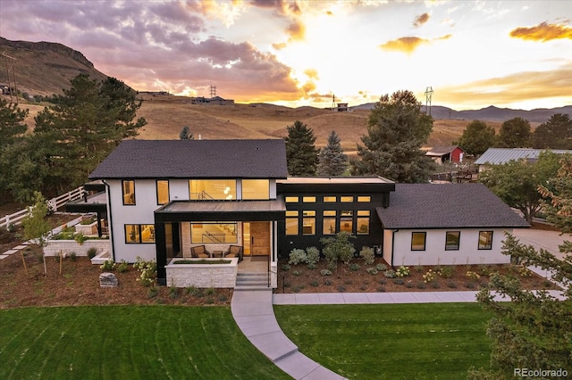 view of front facade featuring a yard and a mountain view