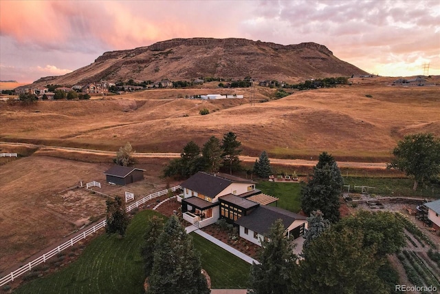 aerial view at dusk with a rural view and a mountain view