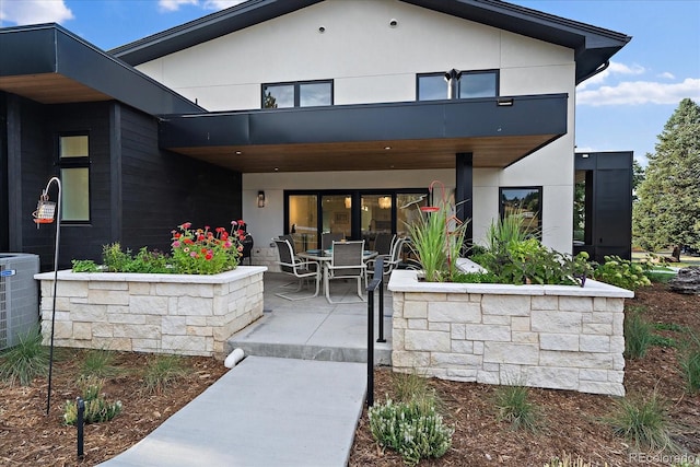 back of house featuring central air condition unit and a patio area