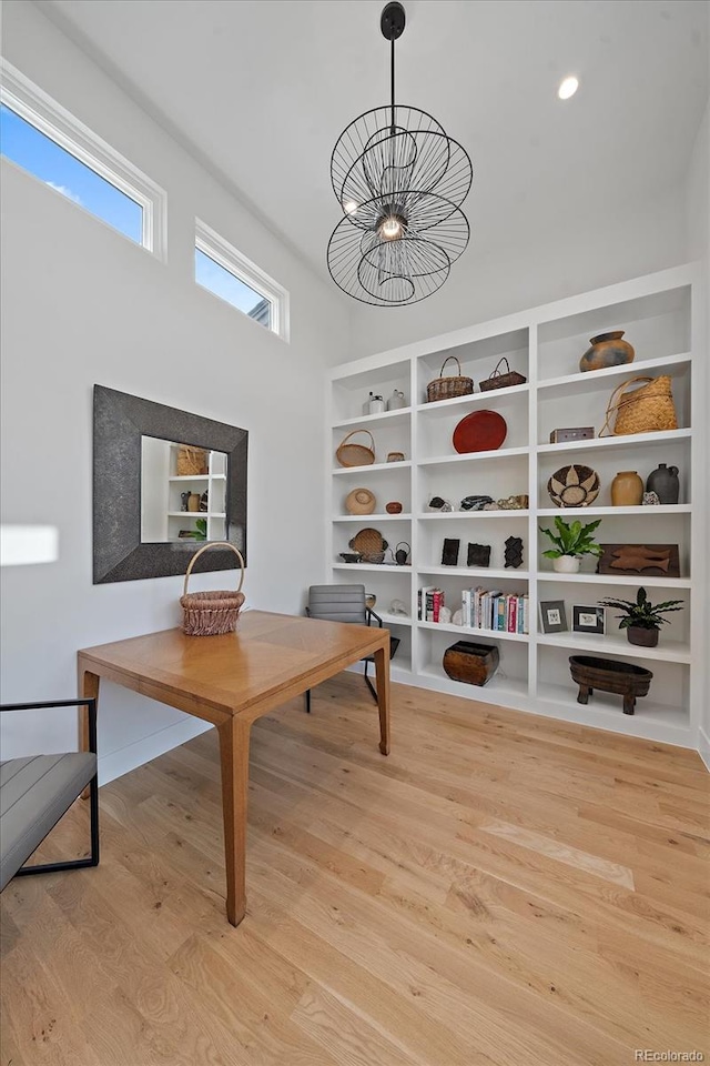 interior space with light hardwood / wood-style floors and a chandelier