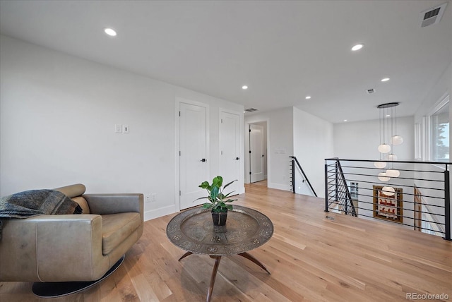 living area with light hardwood / wood-style flooring