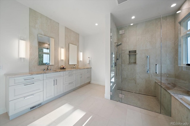 bathroom with walk in shower, tile walls, vanity, and plenty of natural light