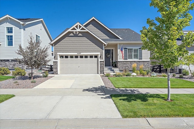 craftsman inspired home with a front yard and a garage