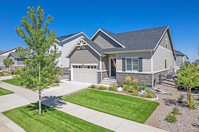 craftsman inspired home with a front yard and a garage