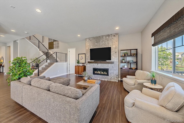 living room with a fireplace and wood-type flooring