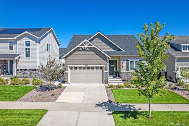 craftsman-style house featuring a front yard and a garage