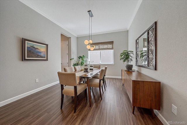 dining area with dark wood-type flooring, a notable chandelier, and ornamental molding