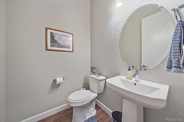 bathroom featuring sink, toilet, and hardwood / wood-style flooring