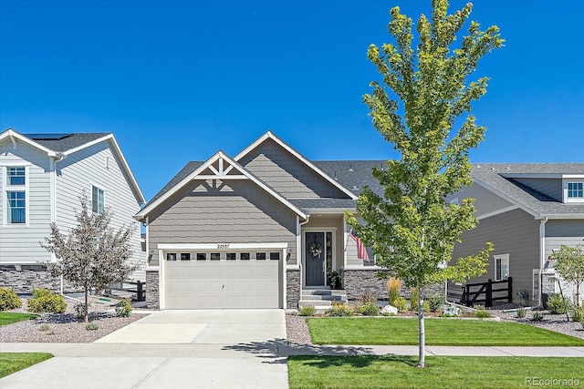 craftsman-style house featuring a front yard and a garage