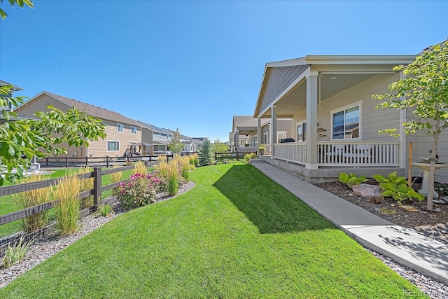 view of yard featuring covered porch