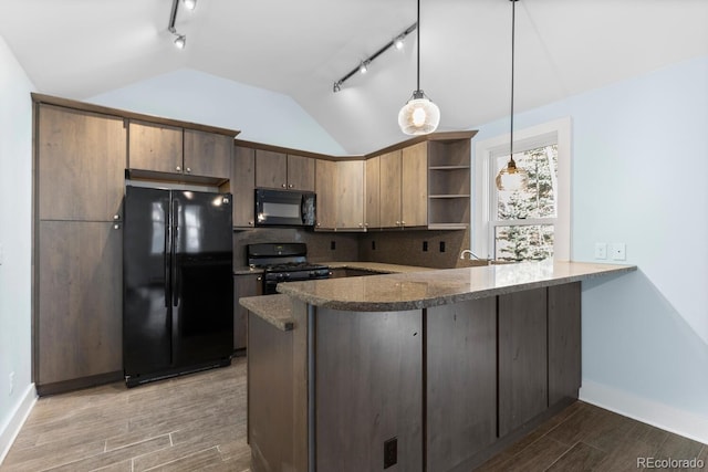 kitchen featuring lofted ceiling, kitchen peninsula, black appliances, and hanging light fixtures