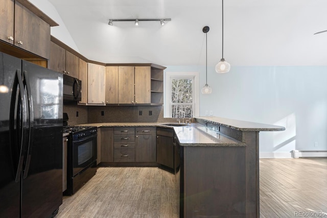 kitchen with decorative light fixtures, light hardwood / wood-style flooring, kitchen peninsula, backsplash, and black appliances