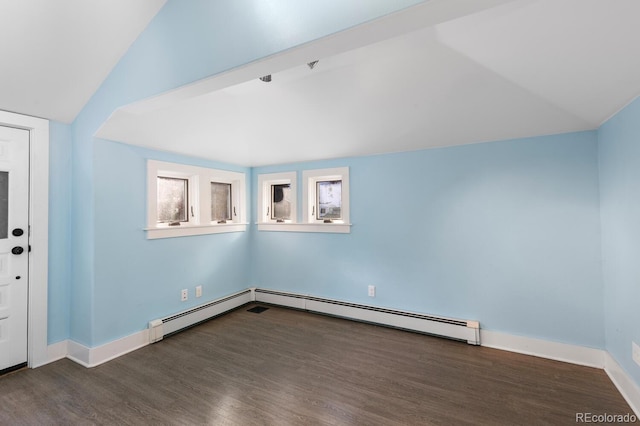 interior space with lofted ceiling, a baseboard radiator, and dark wood-type flooring