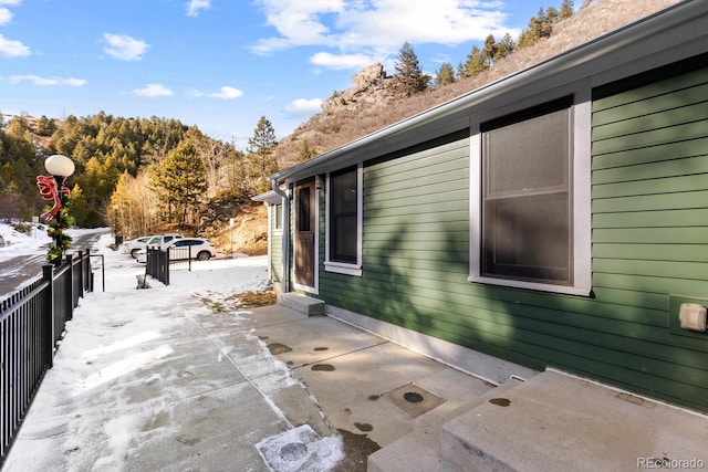 view of snow covered exterior with a patio area