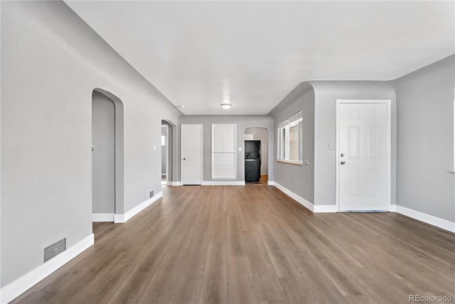 unfurnished living room with wood-type flooring