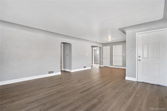 unfurnished living room featuring dark hardwood / wood-style flooring