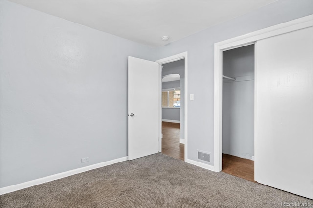 unfurnished bedroom with carpet floors and a closet