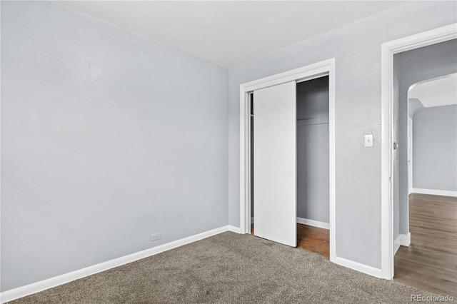 unfurnished bedroom with carpet floors and a closet