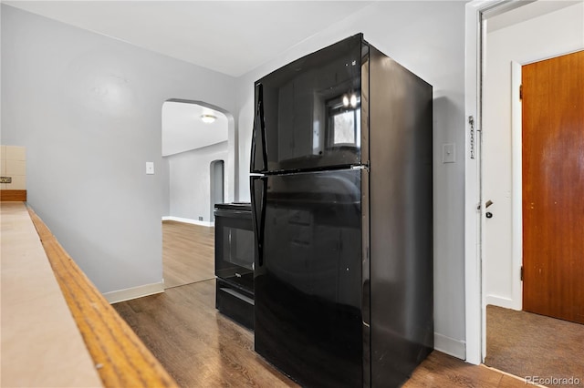 kitchen with black appliances and wood-type flooring